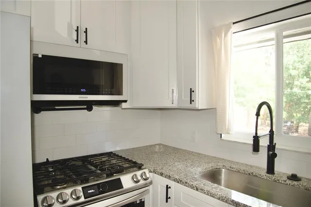 a kitchen with a stove and a sink