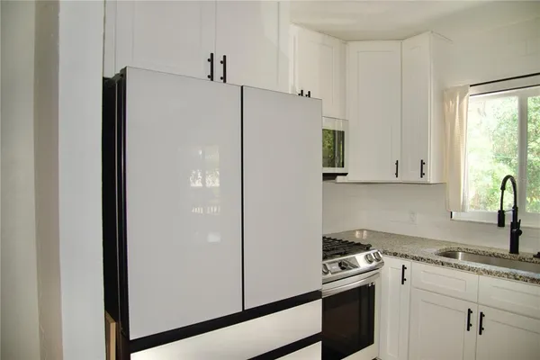 a white refrigerator freezer sitting inside of a kitchen