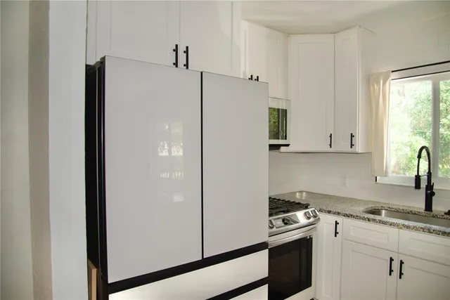 a white refrigerator freezer sitting inside of a kitchen