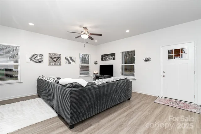 a living room with granite countertop furniture and a flat screen tv