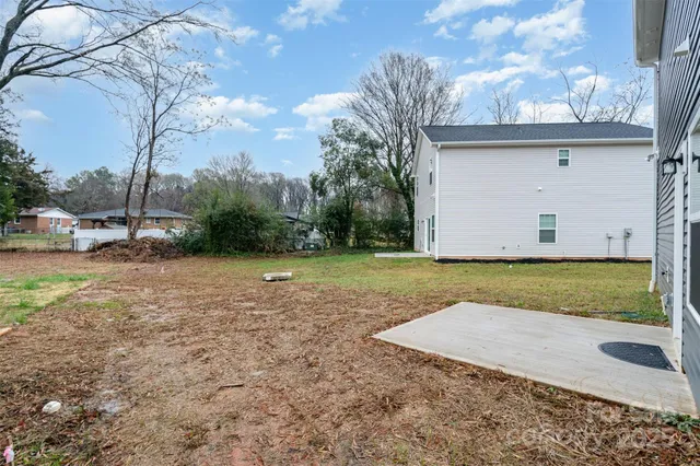 a view of a yard with wooden fence