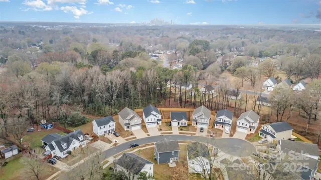 an aerial view of a house with yard and seating space