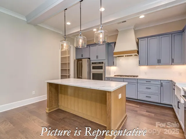 a kitchen with granite countertop a sink cabinets and window