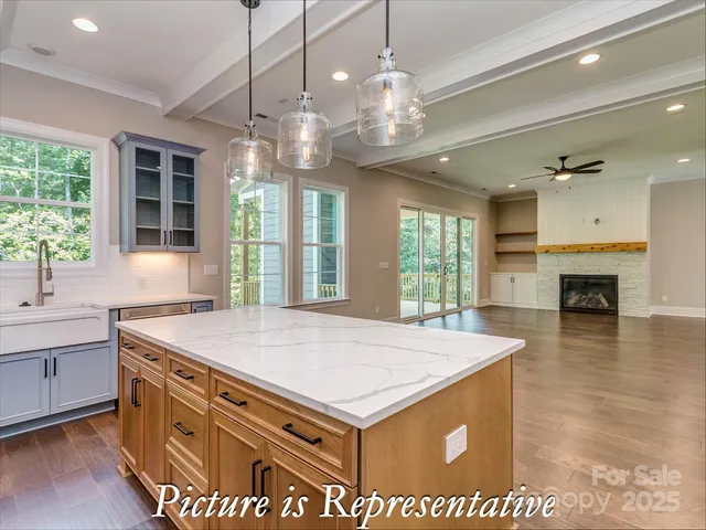 a kitchen with stainless steel appliances granite countertop a sink a stove and a refrigerator