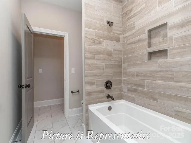 an empty room with windows and a ceiling fan