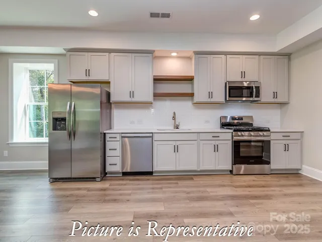 a open kitchen with sink and cabinets
