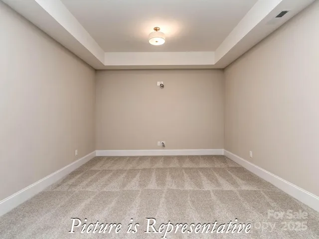 an empty room with wooden floor and outdoor view