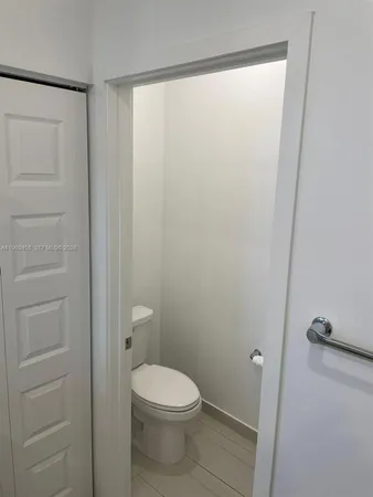 a white toilet sitting next to a bathroom sink
