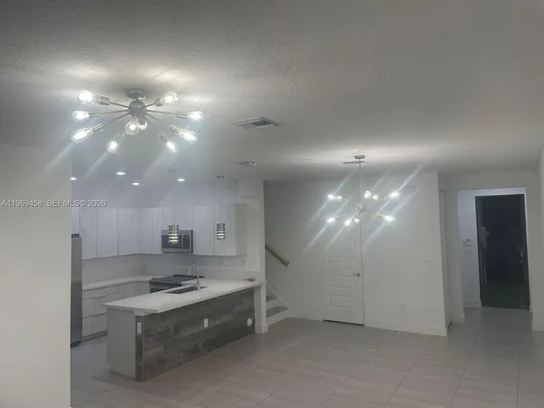 a view of a kitchen with a sink and a stove top oven