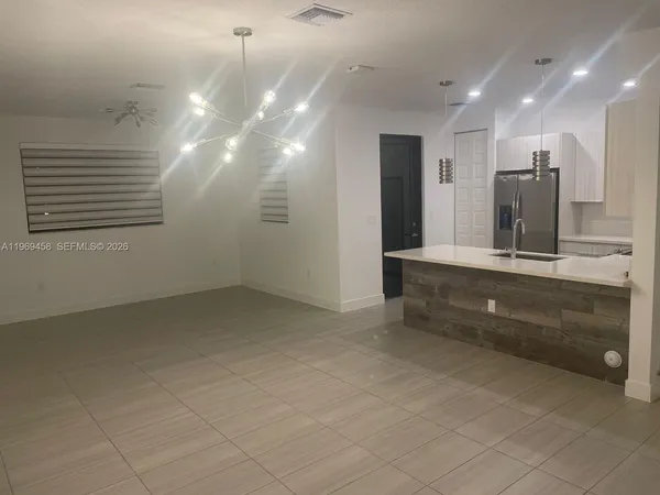 a bathroom with a sink a large mirror and a shower