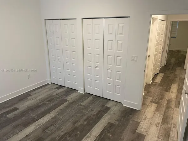 an empty room with wooden floor
