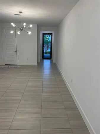 a view of an empty room with a mirror