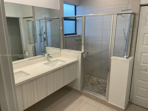 a bathroom with a shower and a sink