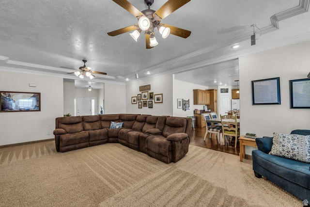 841 1010 S Street St. George, UT 84790 - Photo 6 of 33 Living area featuring crown molding, ceiling fan, recessed lighting, light colored carpet, and a textured ceiling