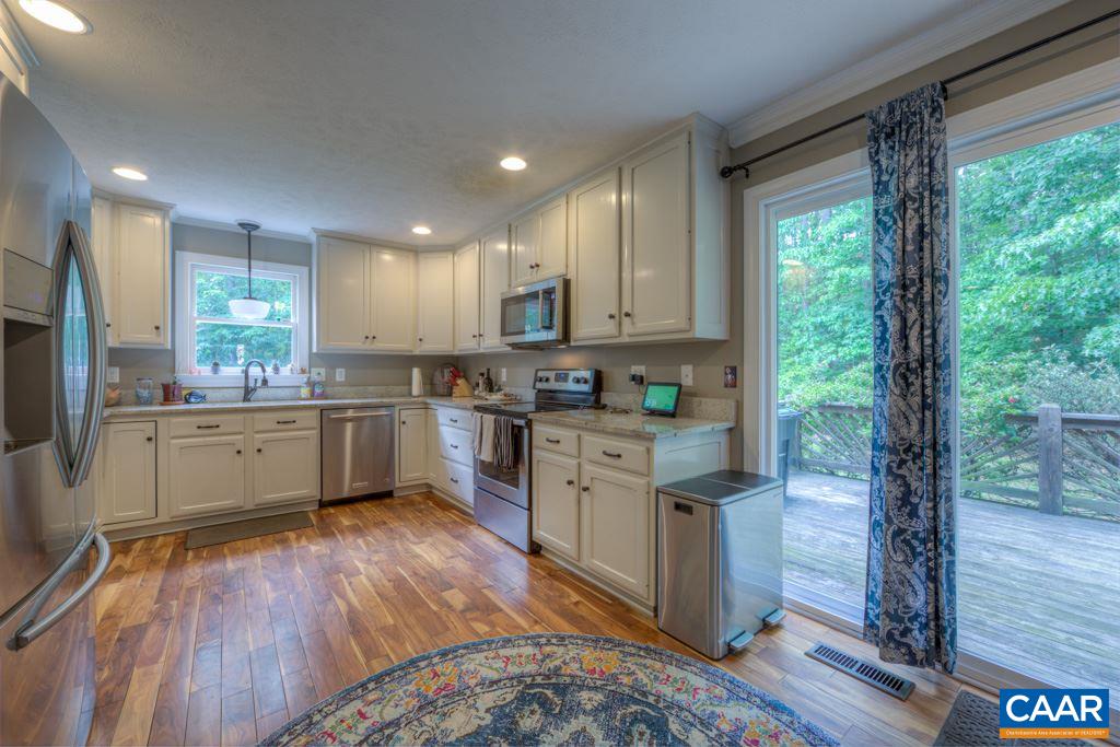 2959 Martin Kings Road Charlottesville, VA 22902 - Photo 11 of 44 a kitchen with stainless steel appliances granite countertop wooden cabinets and a refrigerator