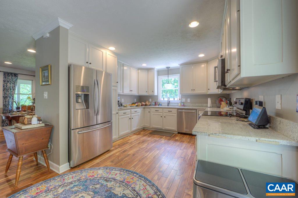 2959 Martin Kings Road Charlottesville, VA 22902 - Photo 12 of 44 a kitchen with refrigerator cabinets and wooden floor