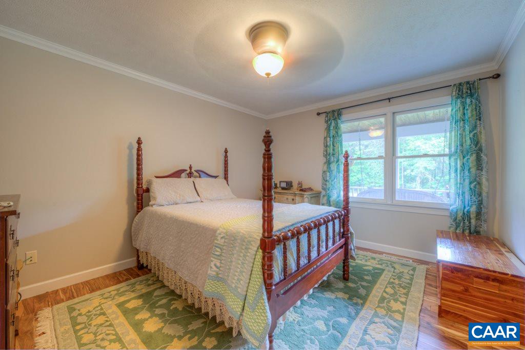 2959 Martin Kings Road Charlottesville, VA 22902 - Photo 15 of 44 a bed sitting in a bedroom next to a window