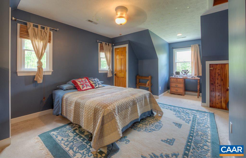 2959 Martin Kings Road Charlottesville, VA 22902 - Photo 23 of 44 a spacious bedroom with a large bed and a dresser