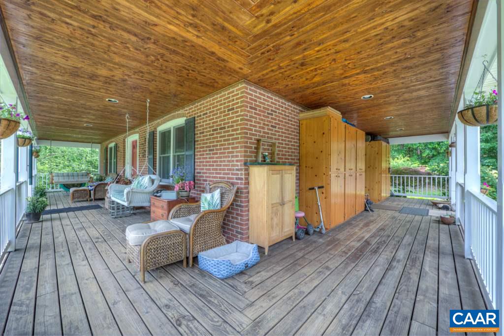 2959 Martin Kings Road Charlottesville, VA 22902 - Photo 5 of 44 a view of a patio with table and chairs barbeque with wooden floor and fence