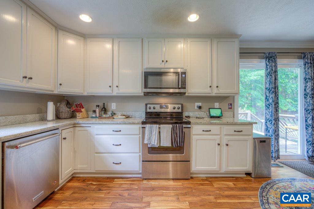 2959 Martin Kings Road Charlottesville, VA 22902 - Photo 10 of 44 a kitchen with granite countertop a stove top oven sink and cabinets