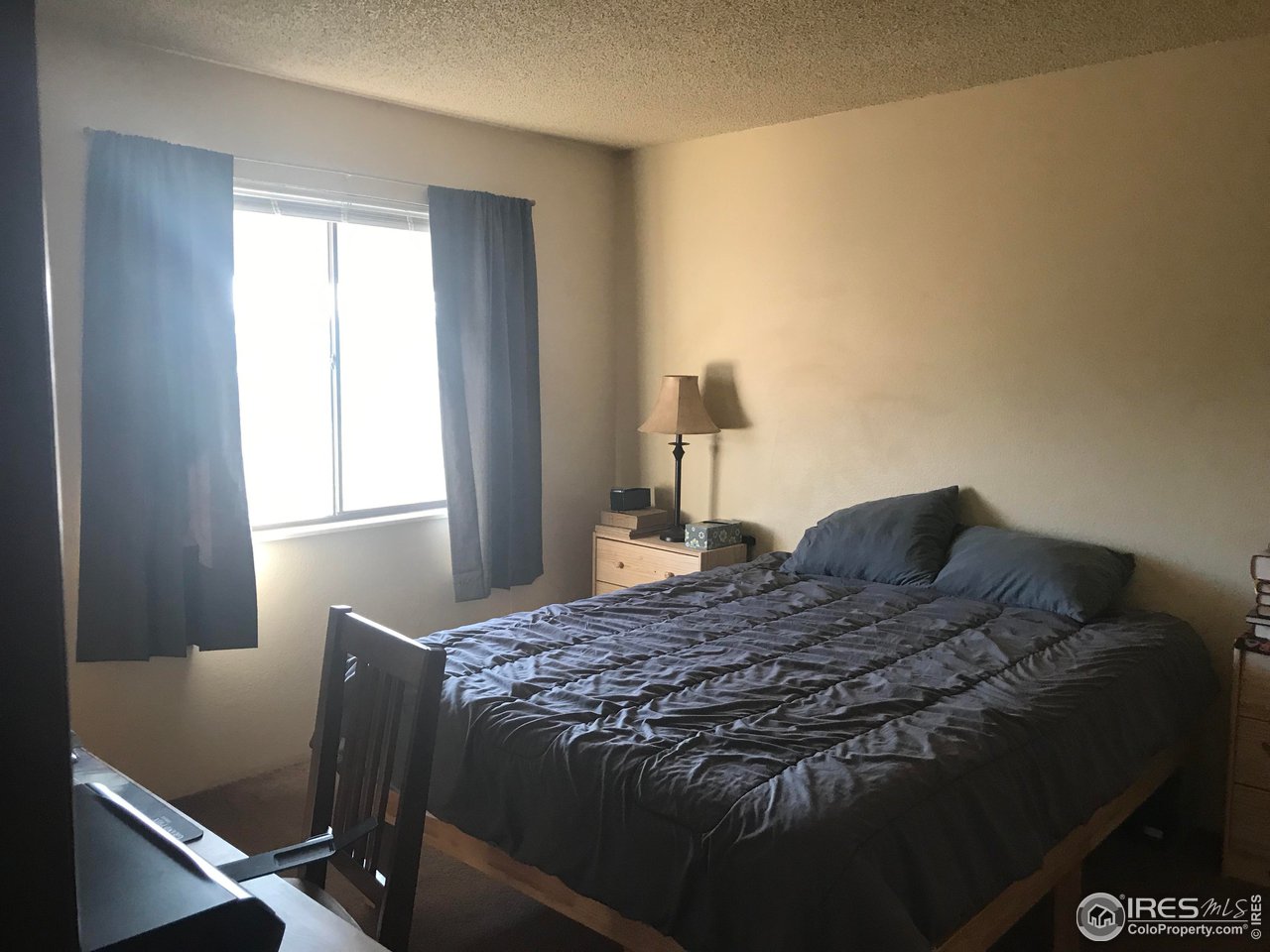 1705 Heatheridge Road, Unit H301 Fort Collins, CO 80526 - Photo 16 of 32 a bedroom with a bed and a window