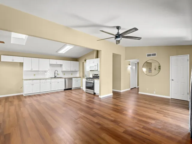 a view of a kitchen with wooden floor and a kitchen