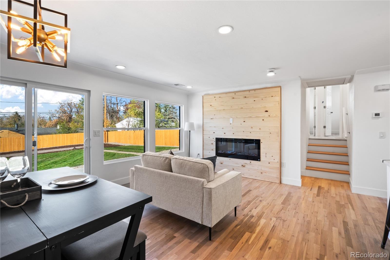 7921 Raleigh Street Westminster, CO 80030 - Photo 11 of 43 a living room with furniture and a fireplace