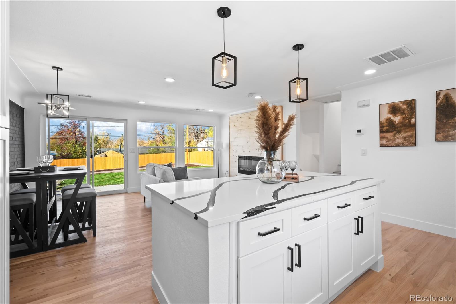 7921 Raleigh Street Westminster, CO 80030 - Photo 12 of 43 a very nice looking kitchen with granite countertop a sink a stove and a wooden floors