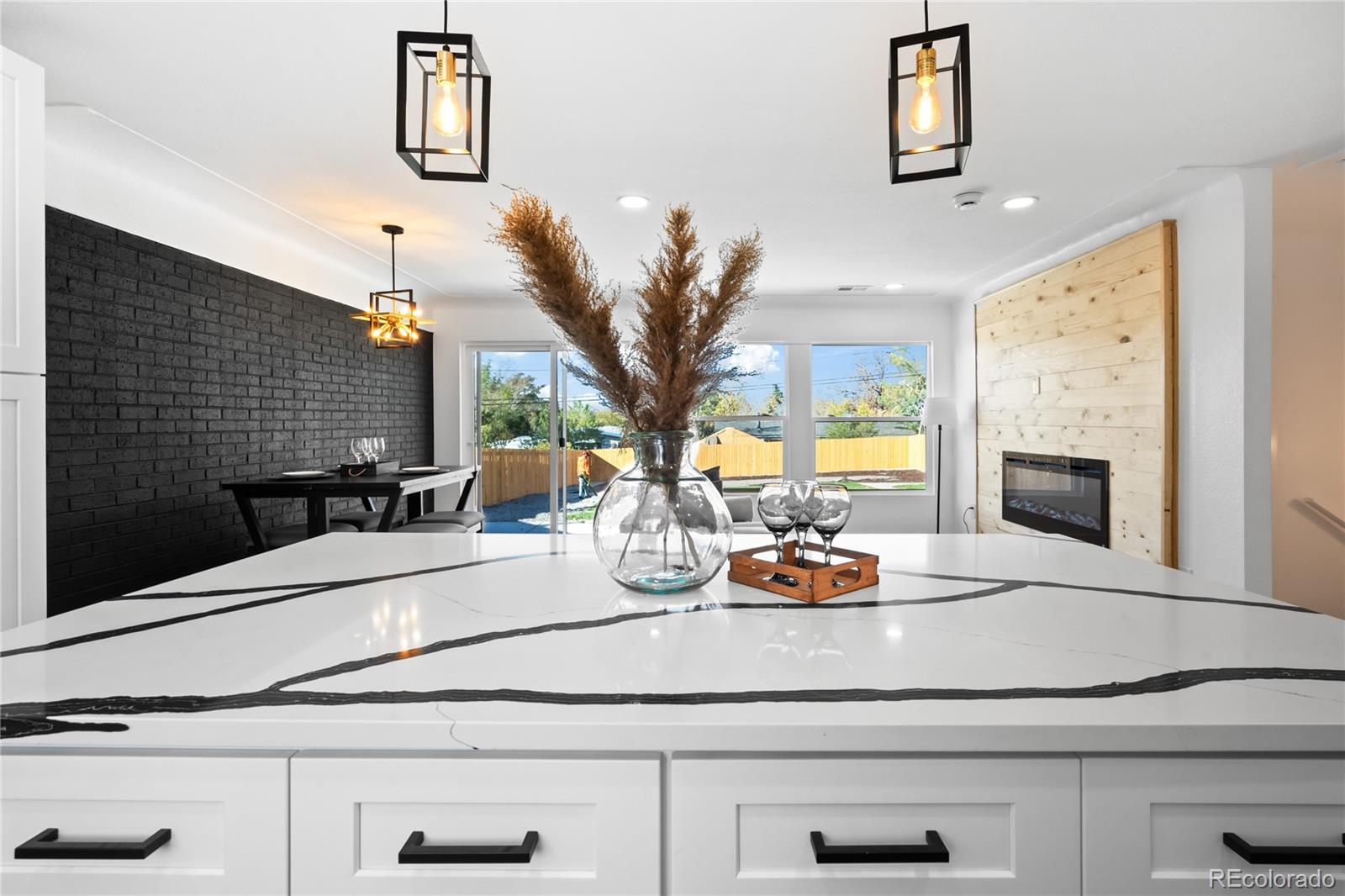 7921 Raleigh Street Westminster, CO 80030 - Photo 13 of 43 a kitchen with a sink and a fireplace