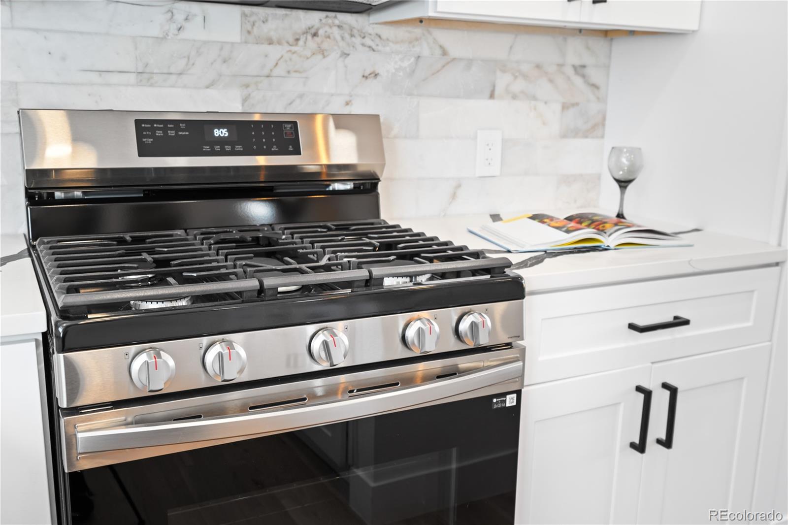 7921 Raleigh Street Westminster, CO 80030 - Photo 16 of 43 a stove top oven sitting inside of a kitchen