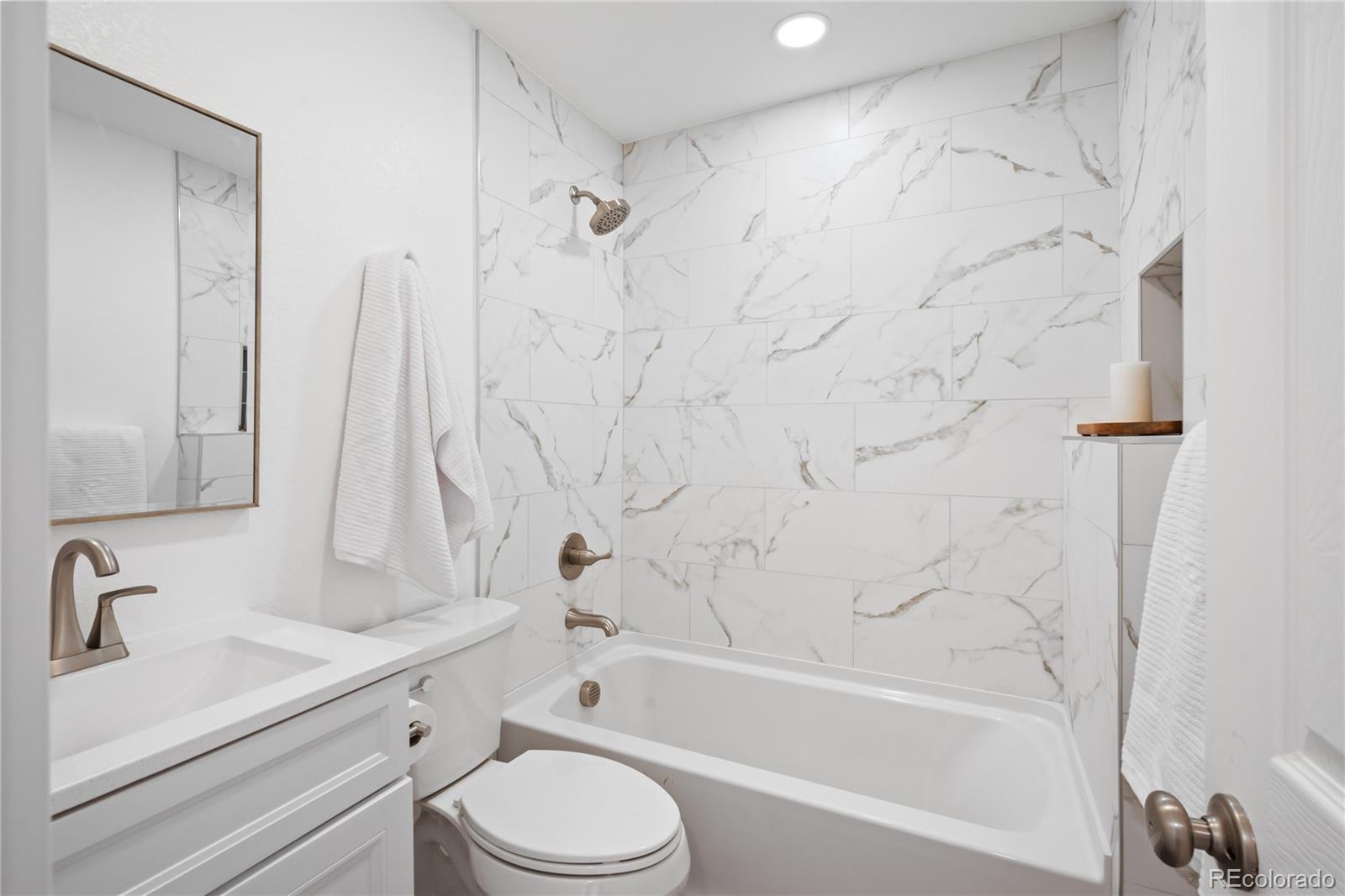 7921 Raleigh Street Westminster, CO 80030 - Photo 20 of 43 a bathroom with a sink toilet and shower