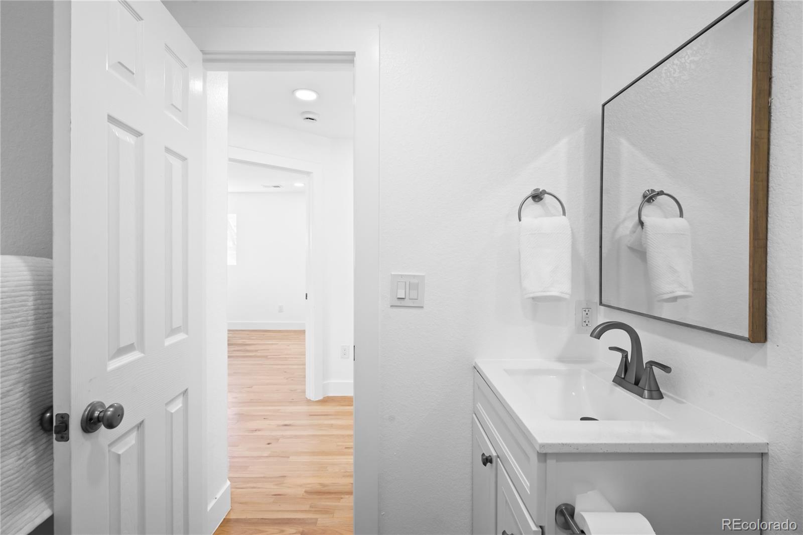7921 Raleigh Street Westminster, CO 80030 - Photo 21 of 43 a bathroom with a sink a mirror and shower