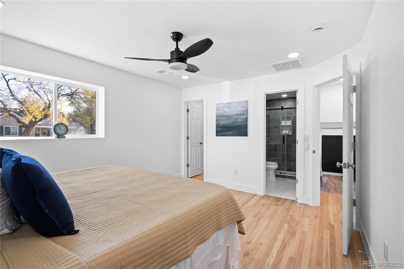7921 Raleigh Street Westminster, CO 80030 - Photo 23 of 43 a bed room with a bed and a view of bathroom