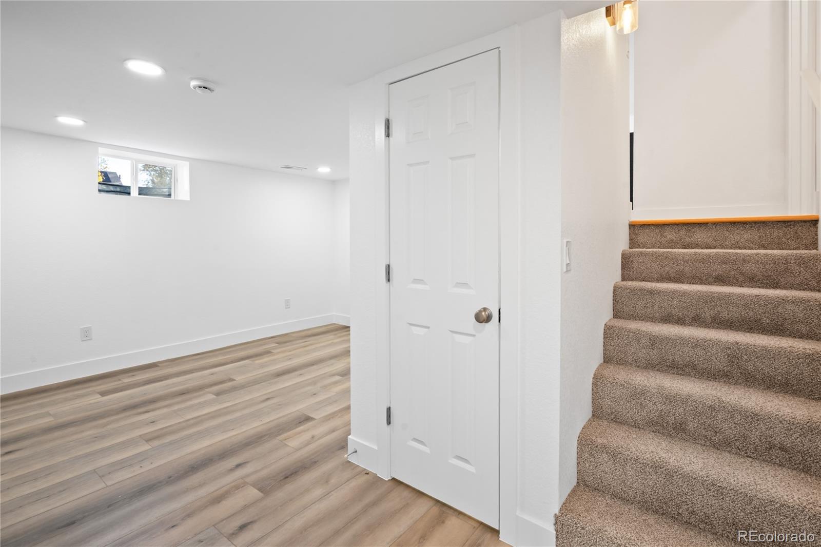7921 Raleigh Street Westminster, CO 80030 - Photo 29 of 43 a view of room with stairs and wooden floor