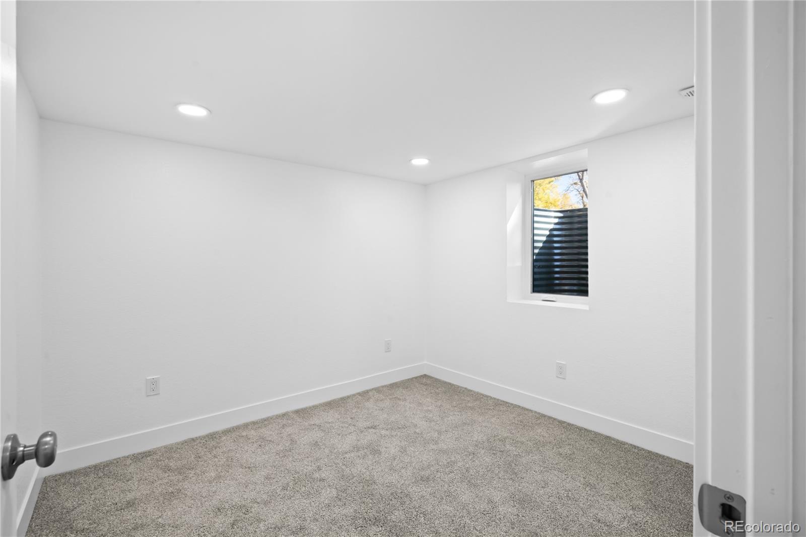 7921 Raleigh Street Westminster, CO 80030 - Photo 32 of 43 an empty room with a window