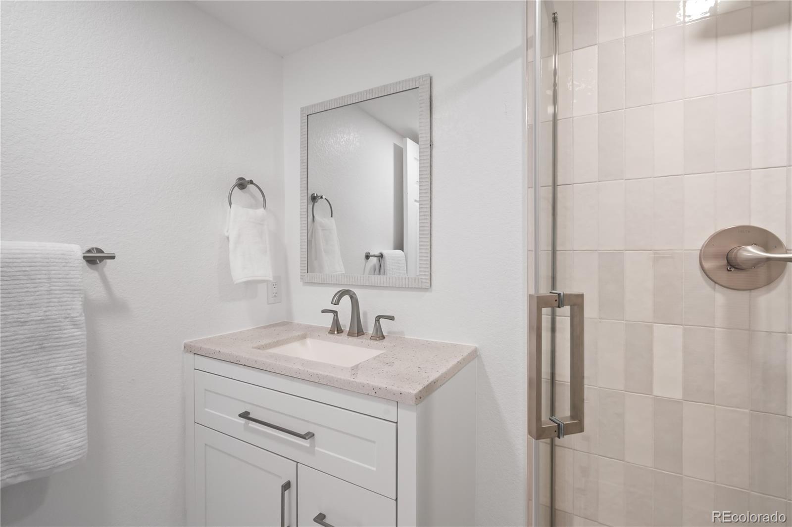7921 Raleigh Street Westminster, CO 80030 - Photo 37 of 43 a bathroom with a sink and a mirror