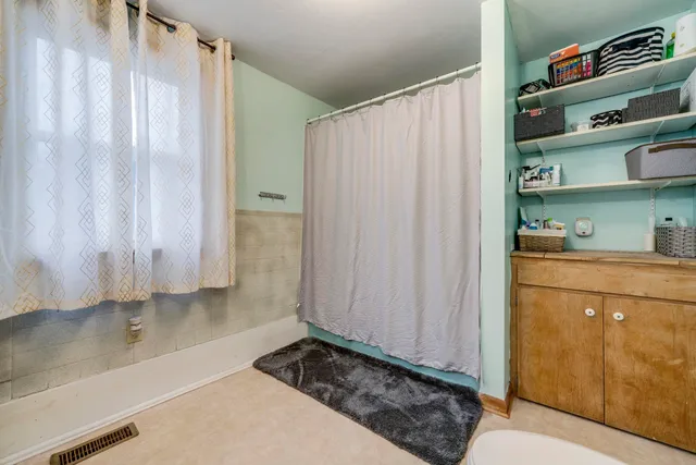 a bathroom with a shower curtain and a sink