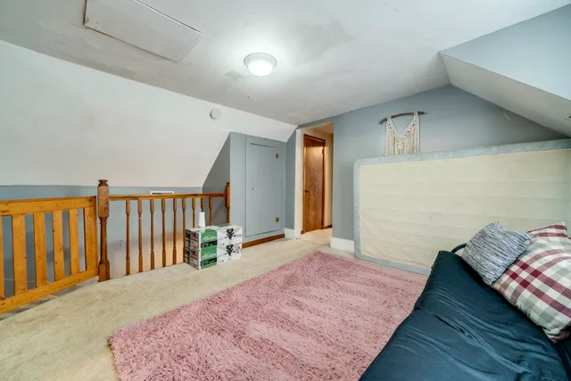 a bedroom with a bed and a book shelf
