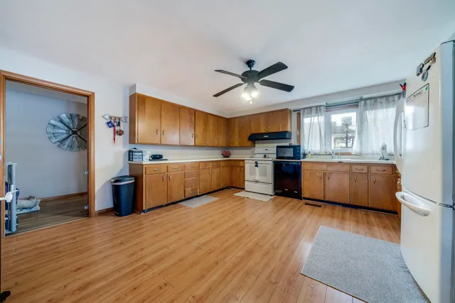 a view of kitchen with cabinets stainless steel appliances and a window