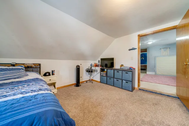 a bedroom with furniture and a flat screen tv