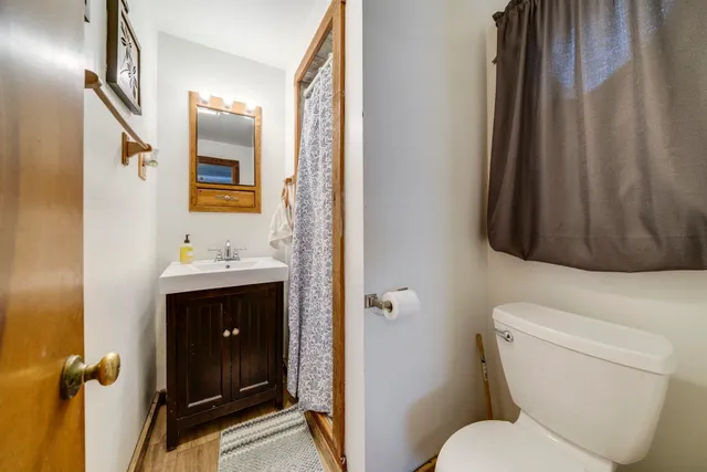 a view of a house with a large space and a road