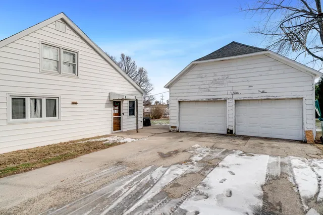 a view of a house with a yard and large tree and wooden fence