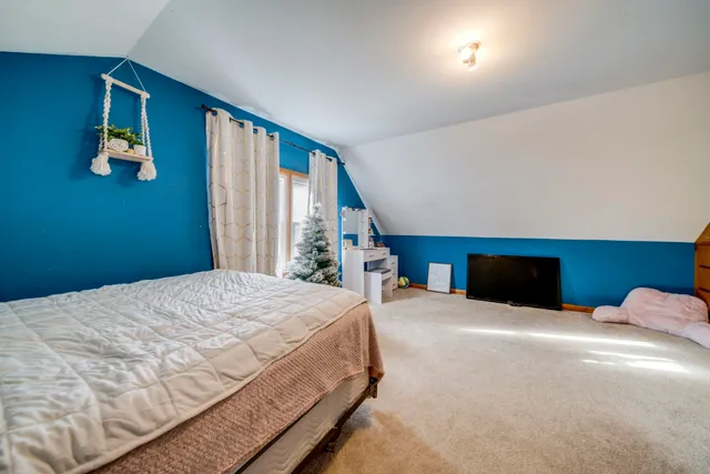 a bedroom with a large bed and a large window