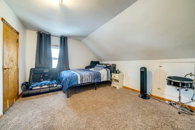 a bedroom with furniture and a window