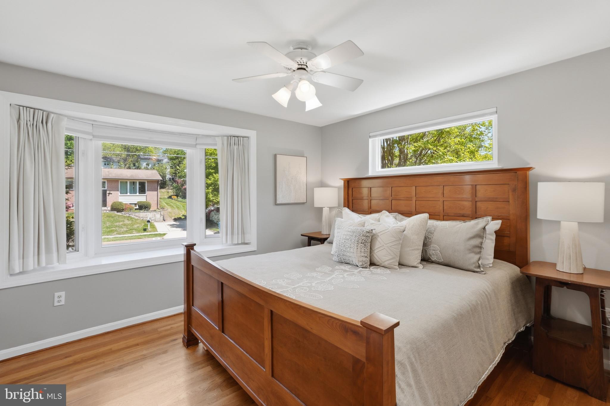 7006 Barnack Drive Springfield, VA 22152 - Photo 23 of 56 a bedroom with a large bed and a chandelier