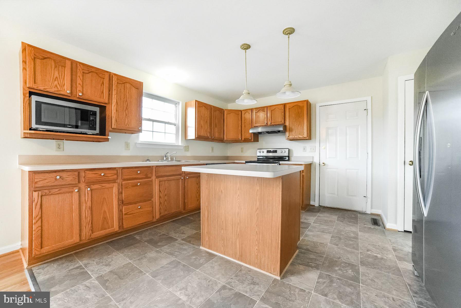 11211 Rawhide Road Lusby, MD 20657 - Photo 5 of 40 Oak cabinets and brand new vinyl flooring