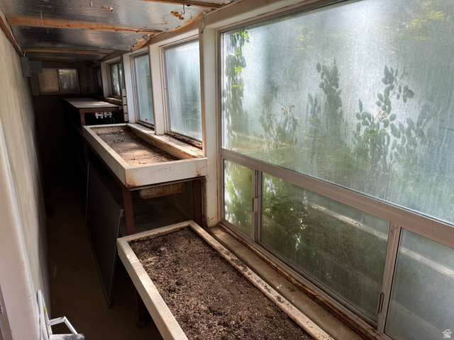 15 West 1600th Street South Mapleton, UT 84664 - Photo 15 of 22 Greenhouse featuring multiple window units, built-in planters, and a metal ceiling