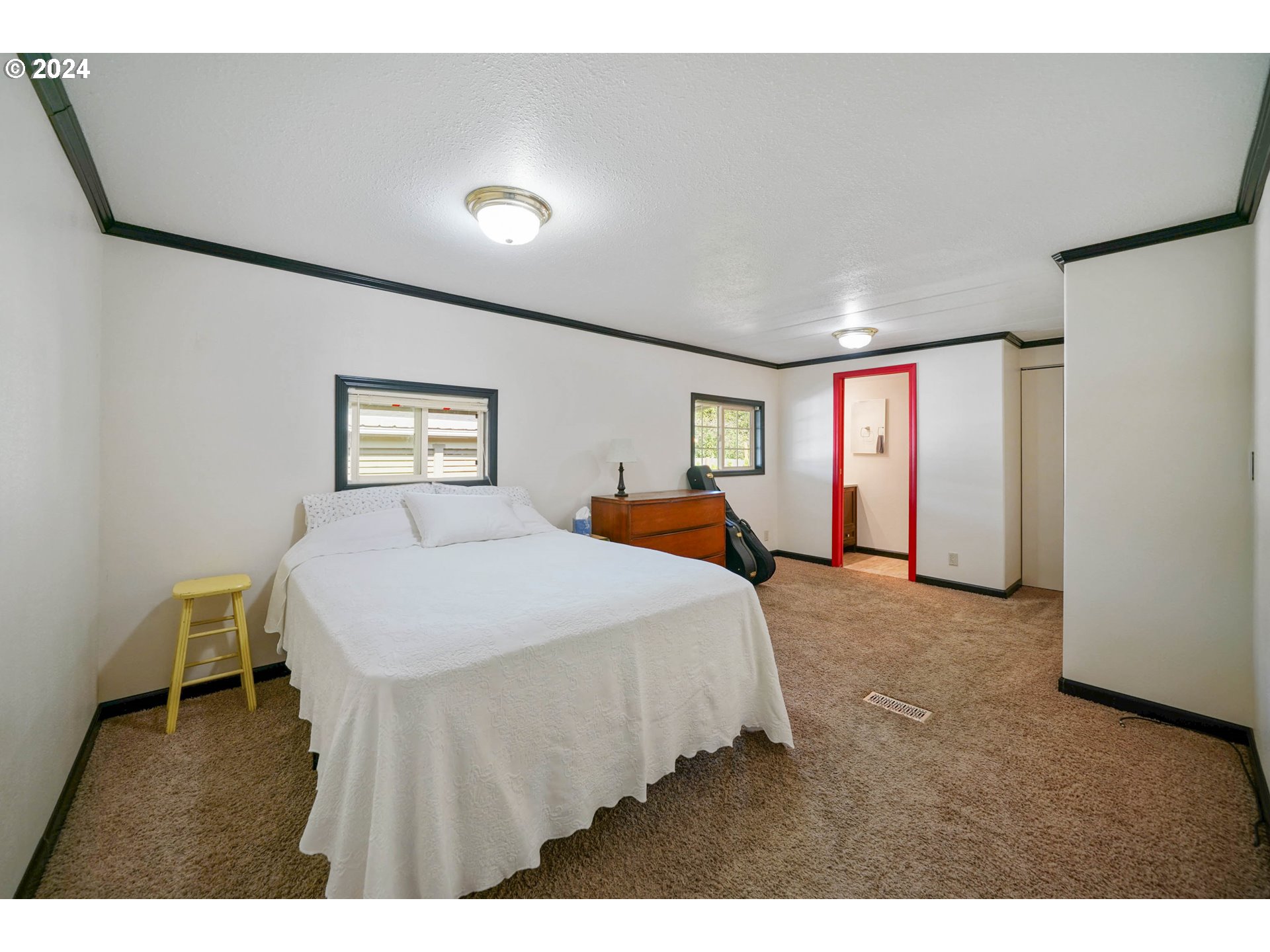 3457 Rainbow Loop Hubbard, OR 97032 - Photo 16 of 32 a spacious bedroom with a bed and a table