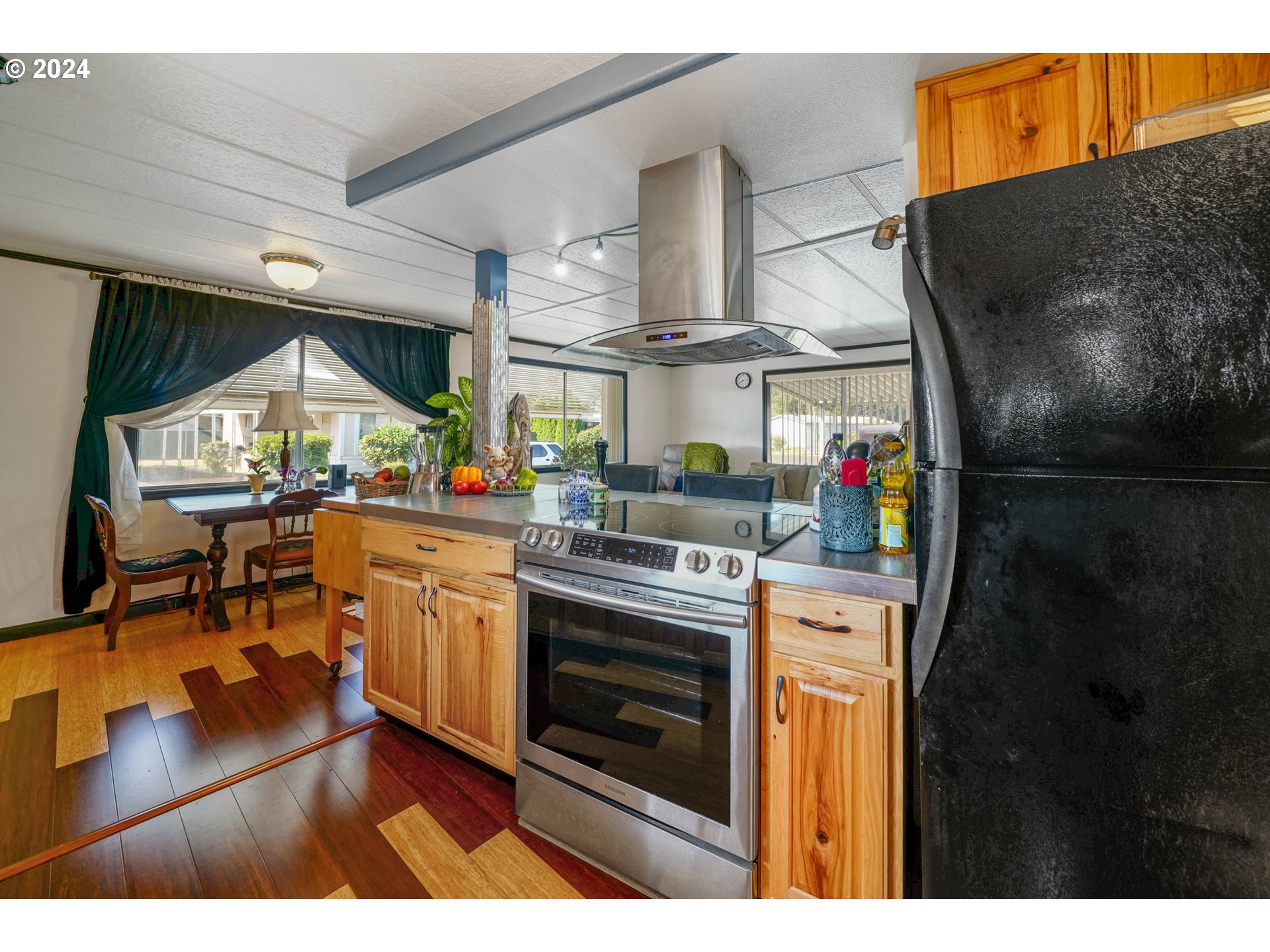 3457 Rainbow Loop Hubbard, OR 97032 - Photo 10 of 32 a kitchen with stainless steel appliances granite countertop a stove and a refrigerator
