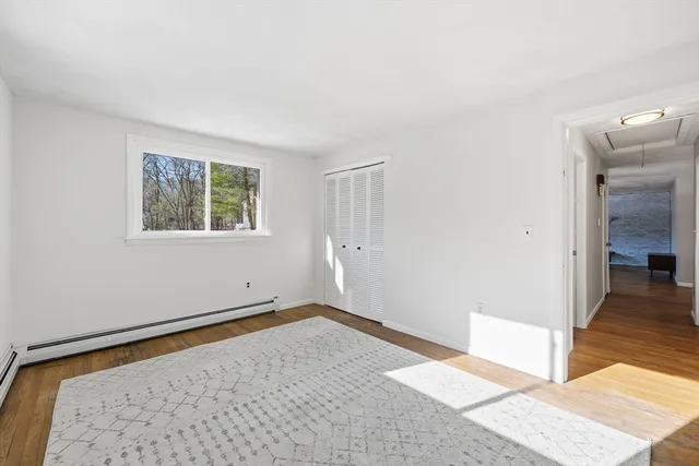 wooden floor in a empty room with a window